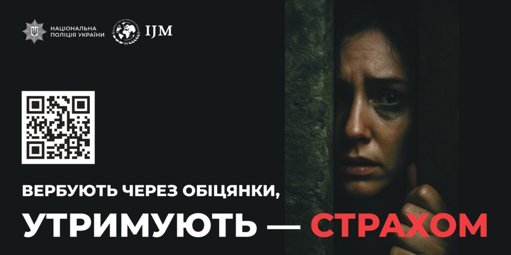 Жінка зі страхом виглядає з-за стовбура дерева на тлі напису про те, що людей вербують через обіцянки і утримують страхом.