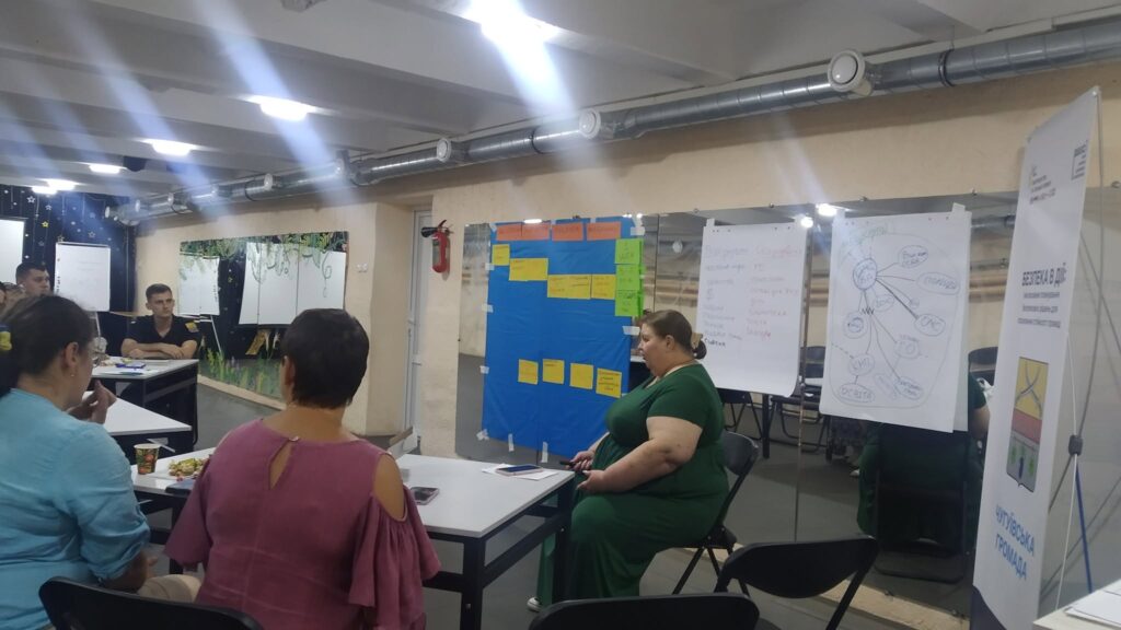 Учасники тренінгу «Відтеча в дії» обговорюють стратегію біля робочих столів та інформаційних стендів.